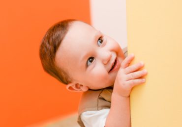 child peeking around video