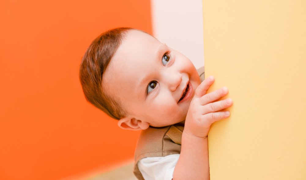 child peeking around video