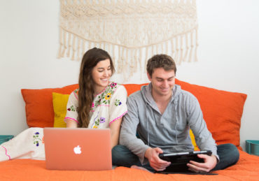 couple looking at finances on devices