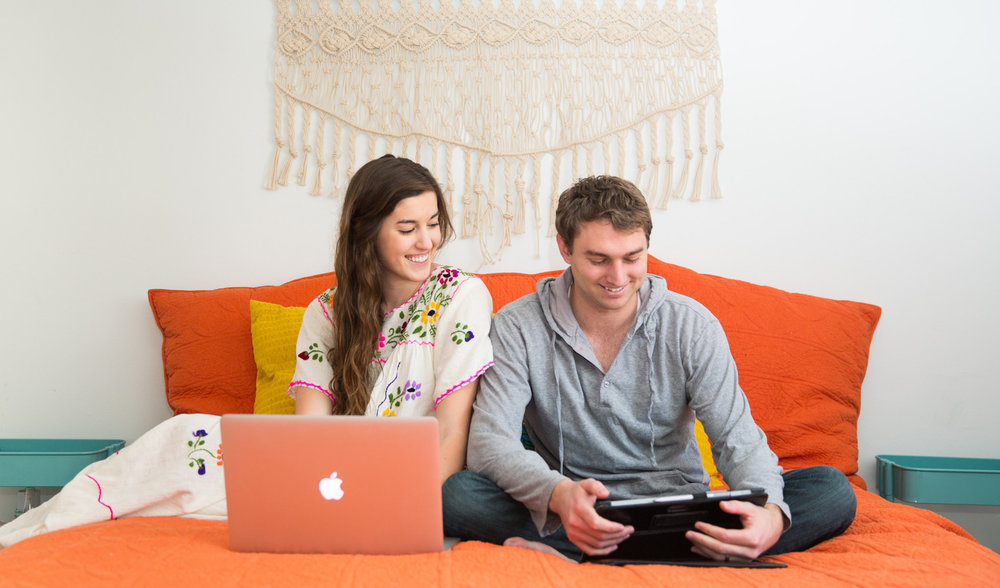 couple looking at finances on devices