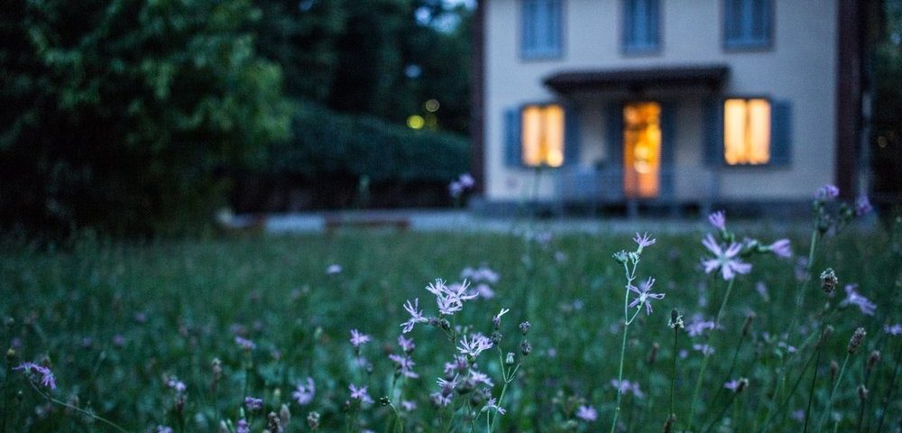 FirstHouse house and a field