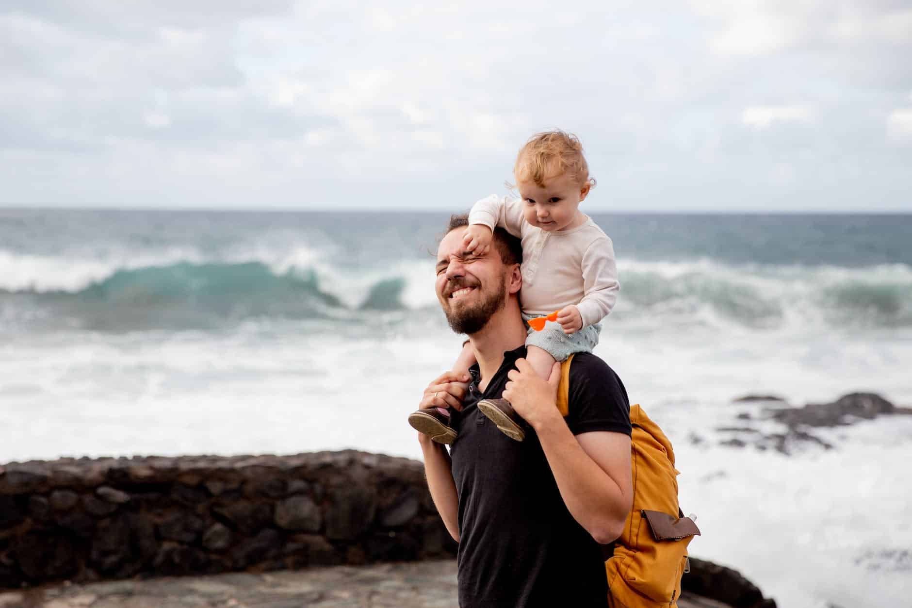 pexels photo 3968151 man in black shirt carrying little kid on his shoulder
