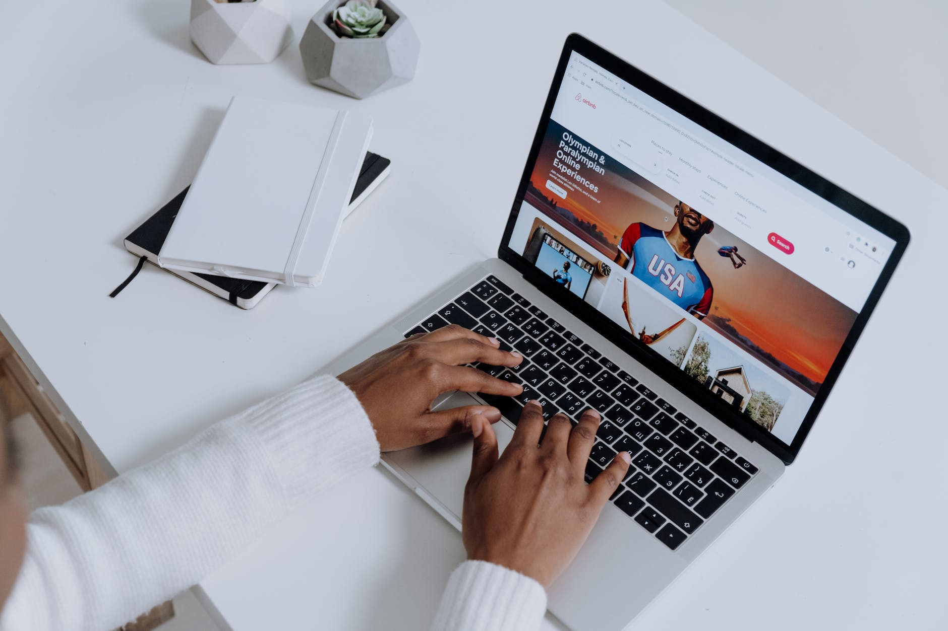 pexels photo 5077048 person using a macbook pro on a white table
